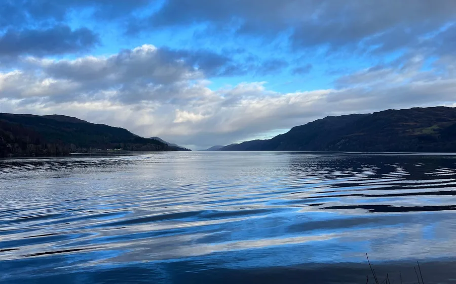 The dark water of Loch Ness under Highland cloud